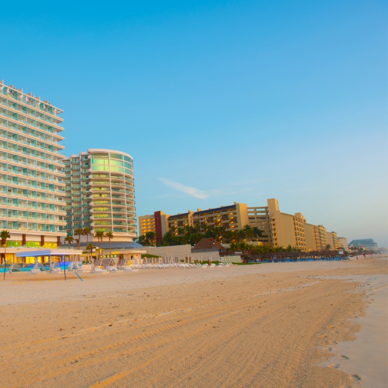 Cancun Beachfront Resorts along a sandy beach.
