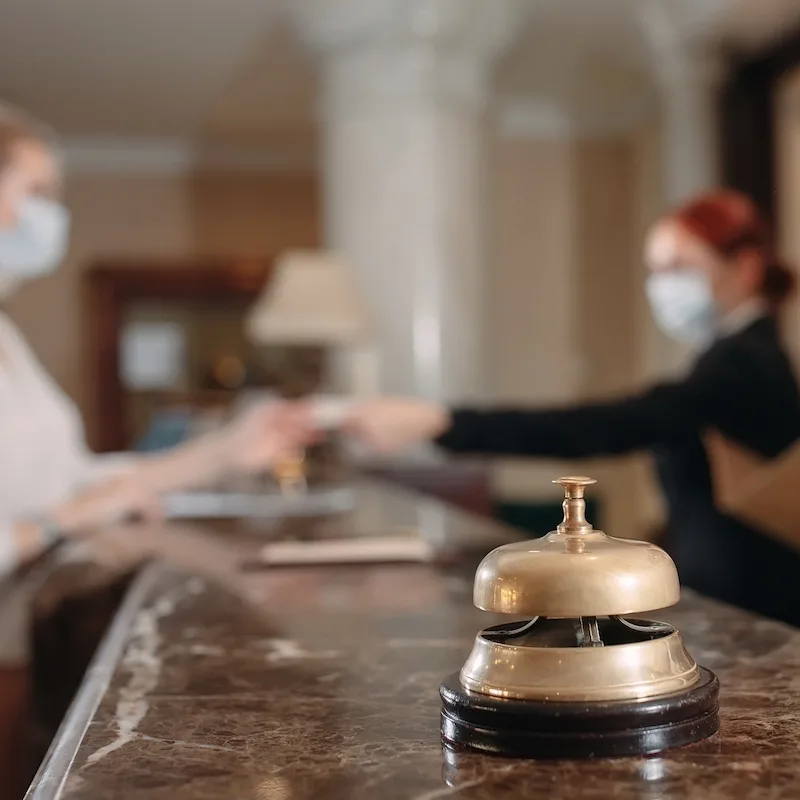 Reception bell with a customer and receptionist interaction in the background