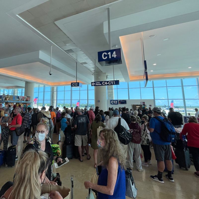 Cancun airport passengers in terminal waiting on flights
