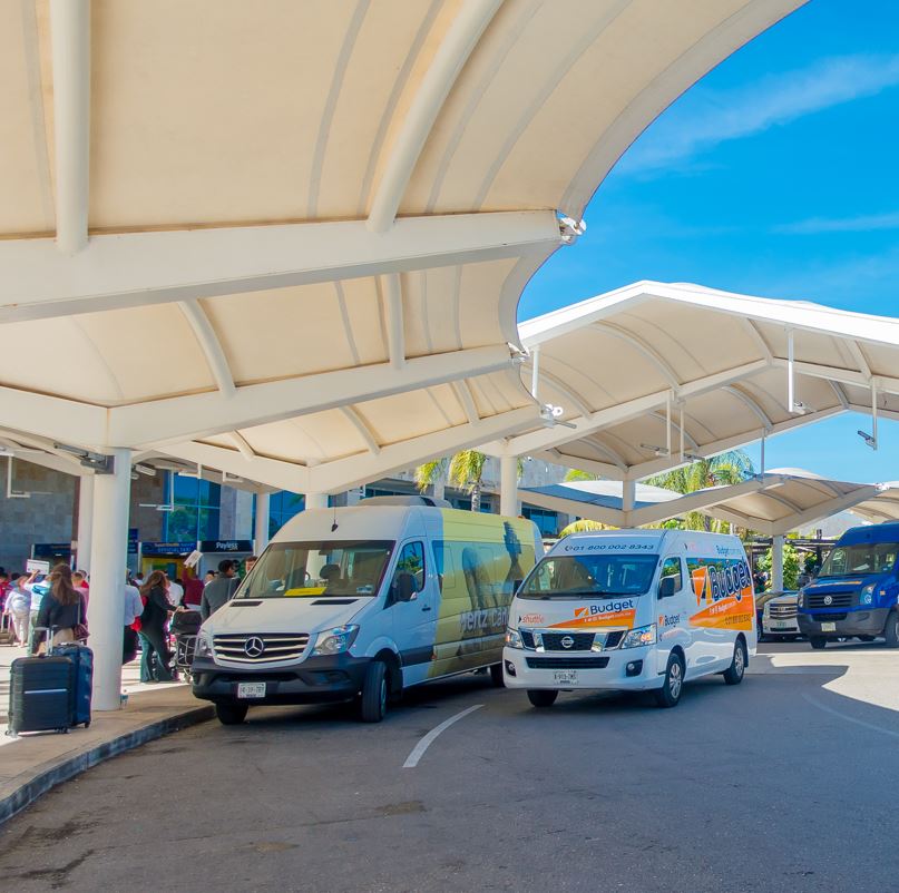 Cancun airport pickup area with tourists looking for their cars