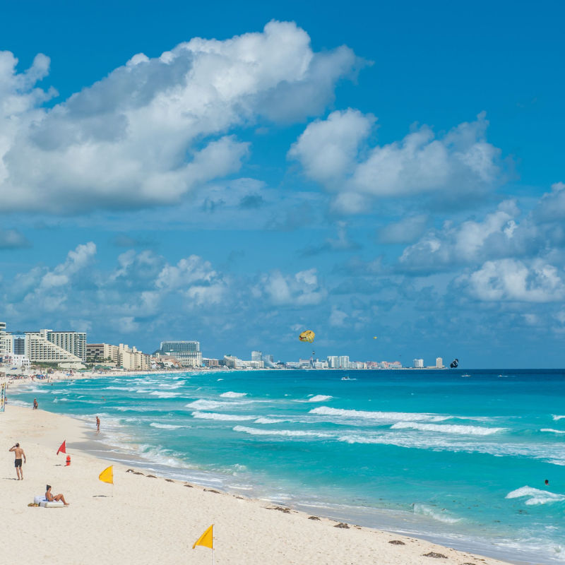 Overview of one of Cancun's beaches with travelers