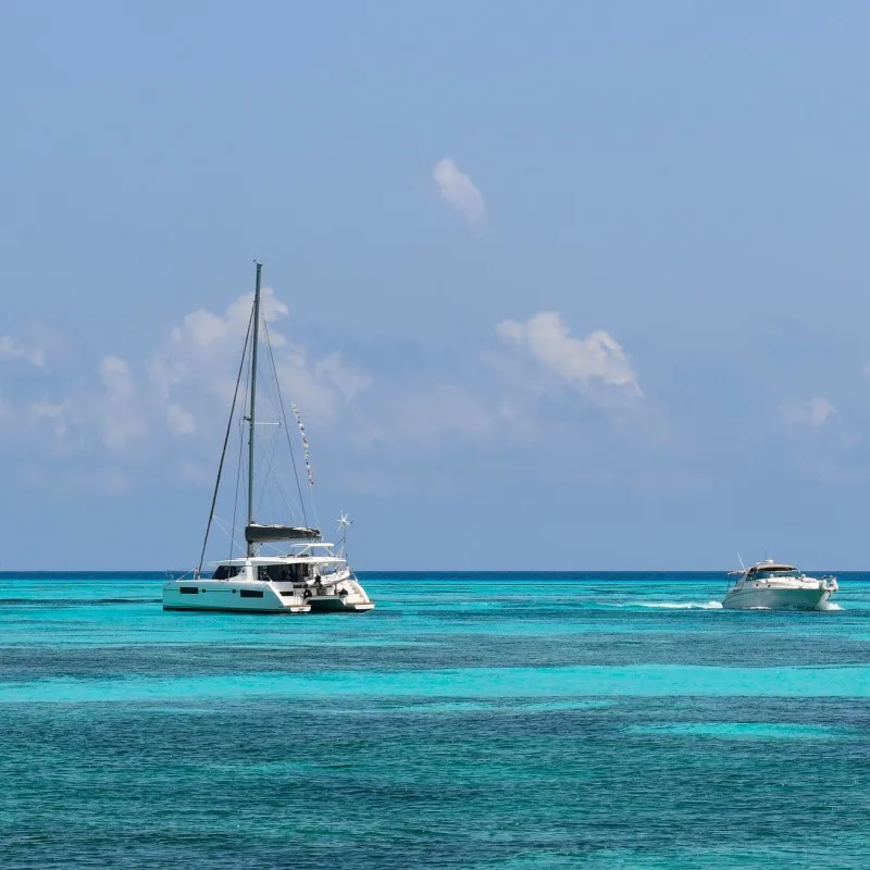 Catamaran and Boat on the Turquoise Blue Water in Cancun.