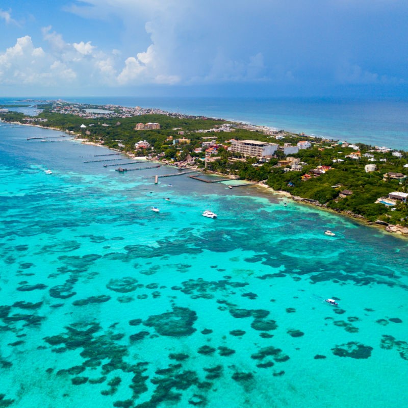 Coast of Isla Mujeres with beautiful aqua blue water as far as the eye can see.