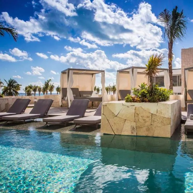 infinity pool and chairs at Majestic Elegance Costa Mujeres resort in Cancun.