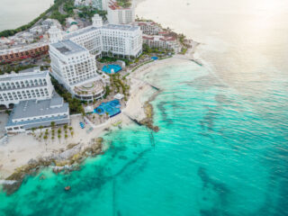 Aerial View Cancun Hotel Zone by the carribean coast with clear blue crytstal waters on a sunny day