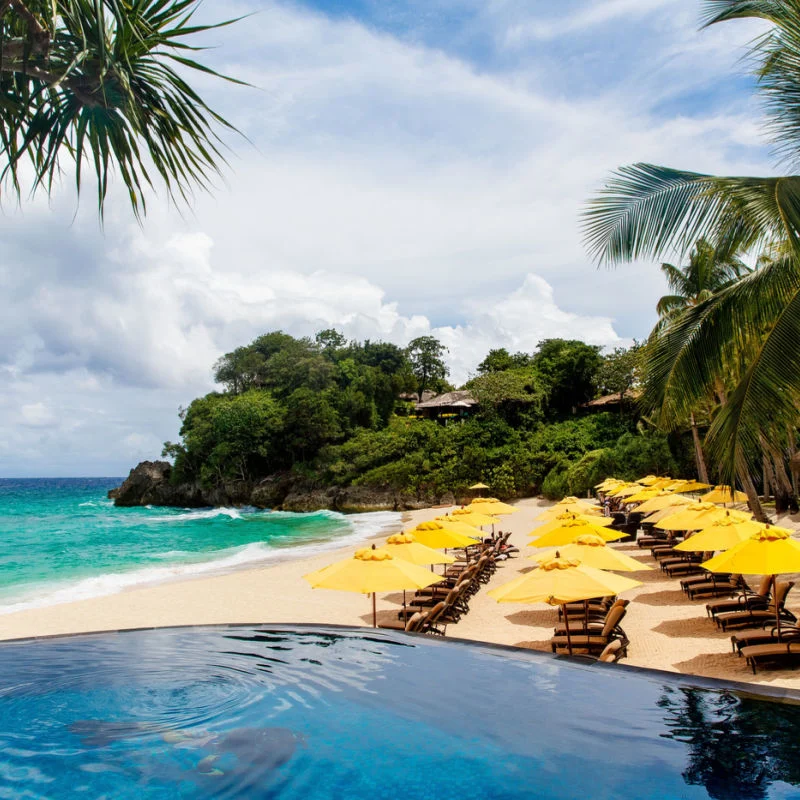 Pool area in Isla Mujeres with palm trees and beach