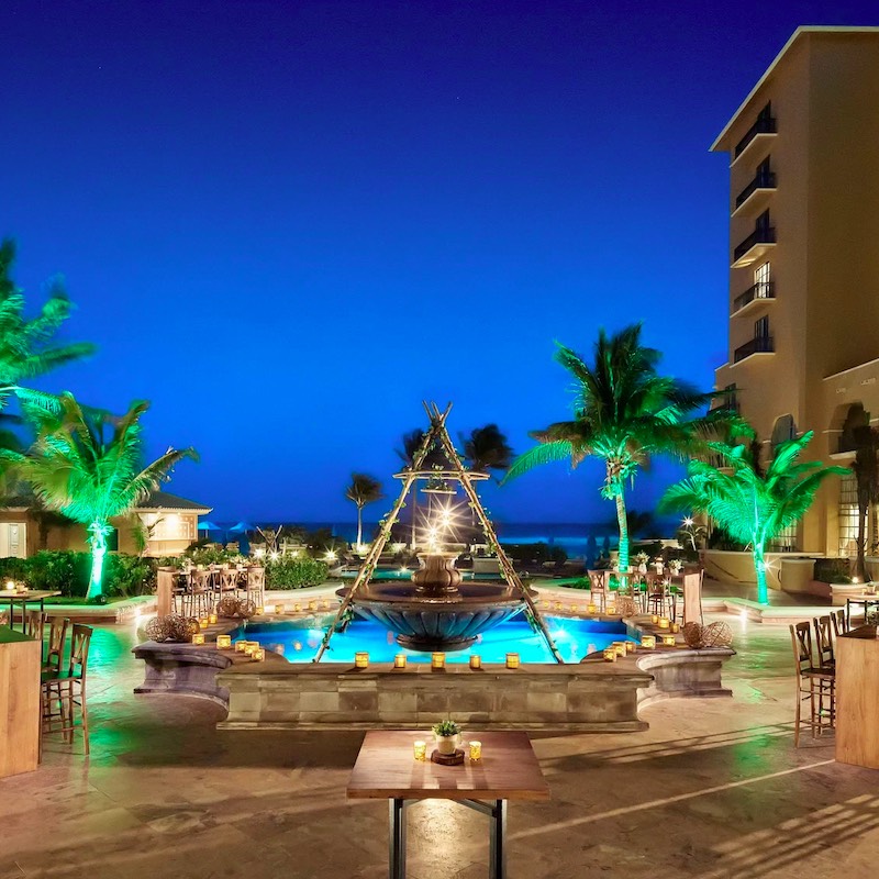 outdoor pool and lounge area in the evening, lit up at the Kempinski Hotel Cancun