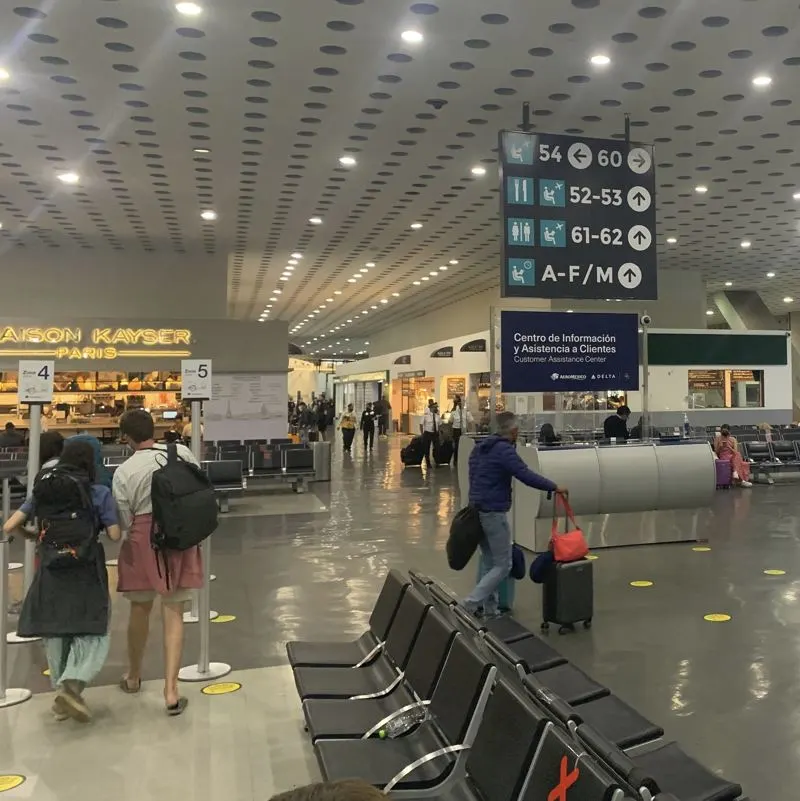 Lady and daughter walking in cancun airport with luggage