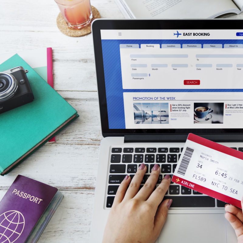 Person using a computer to book a travel service 