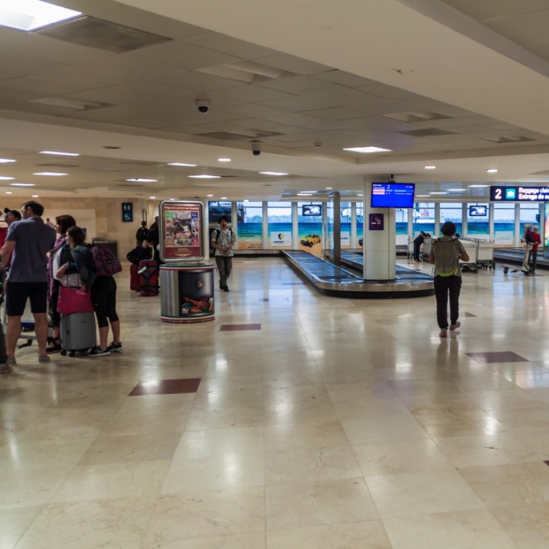 People Waiting at Baggage Claim at Cancun Airport.