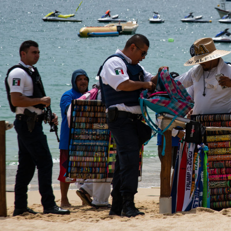 Officers inspecting a beach area and salesperson
