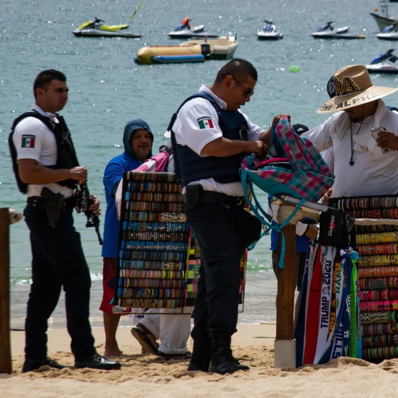 Officers inspecting a beach area and salesperson 