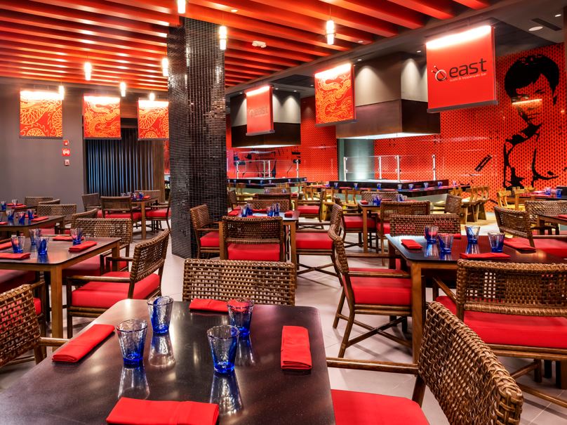 Restaurant with red decor and art on the wall at Planet Hollywood Cancun.