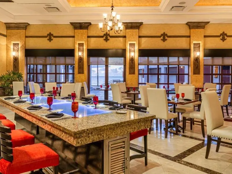 Restaurant at Villa del Palmar with tables, chairs, and place settings.