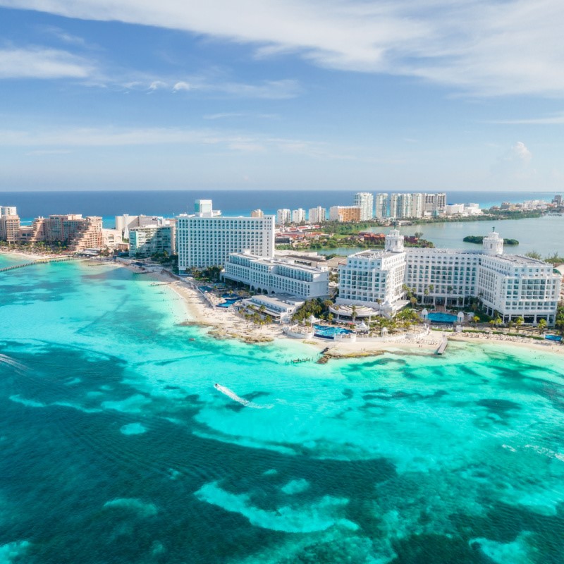 Cancun beaches and hotels near the blue water.