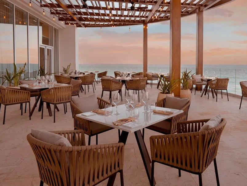 Seaside Restaurant at Sun Palace in Cancun with tables and chairs and place settings.