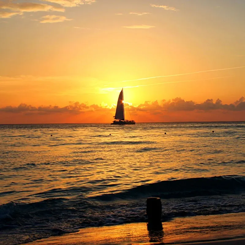 Sunset Cruise in Cancun with the Sun Setting in the Background.