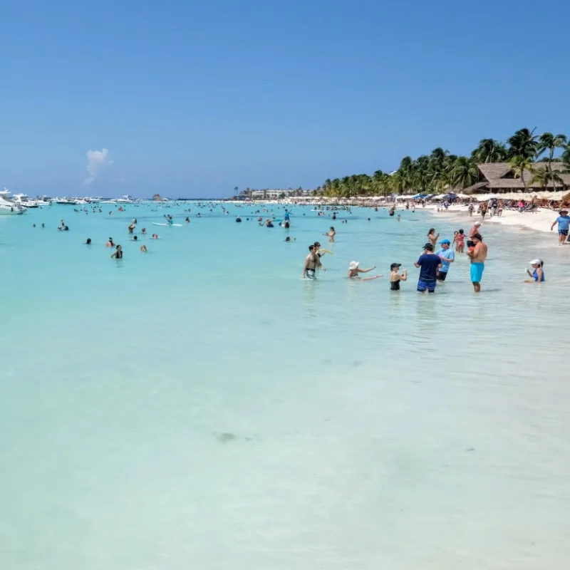 Tourists Swimming in the aqua blue water in the Water in Isla Mujeres.