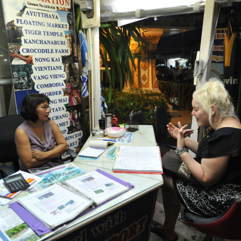 Woman purchasing services from travel agency 