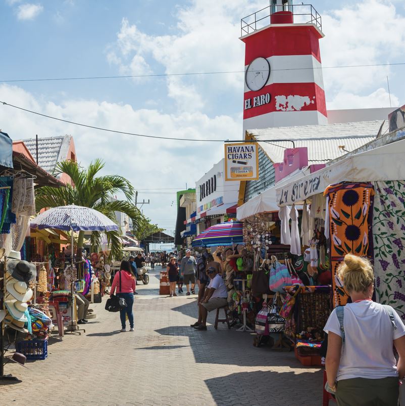 tourists walking outdoor shopping in downtown San Miguel de Cozumel Mexico on sunny day