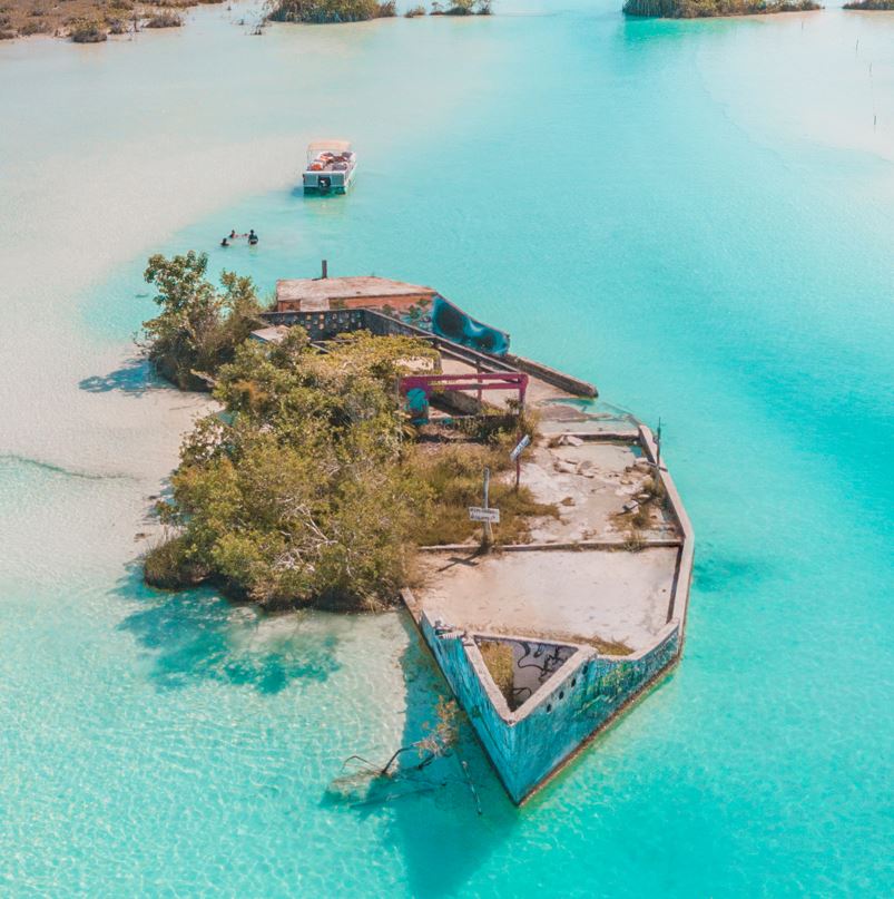 Aerial view of lagoon in bacalar with a boat in the water