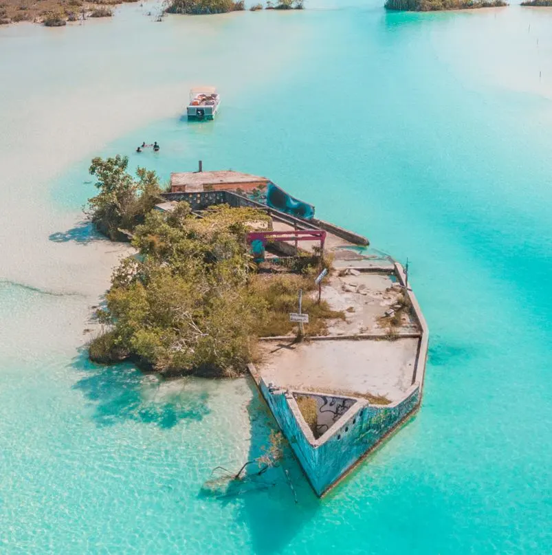Aerial view of lagoon in bacalar with a boat in the water