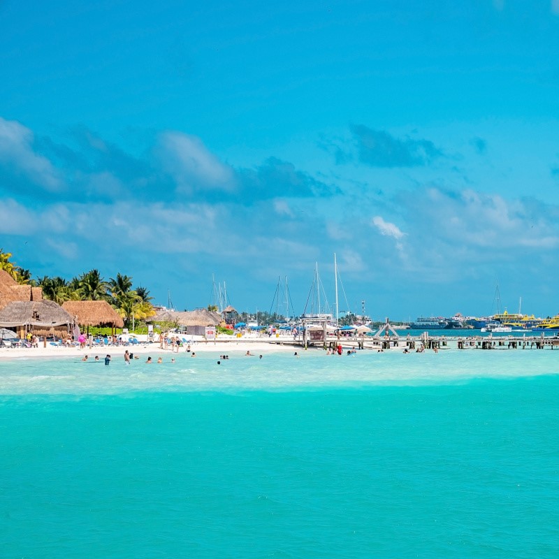 Boats and Tourists in the Aqua Blue Water in Cancun