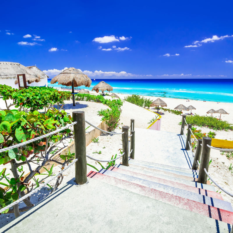 Stairways leading to a white sand beach in Cancun