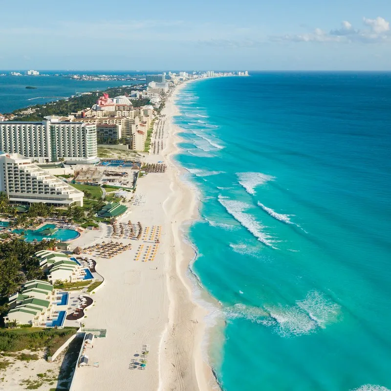 Cancun beach panorama aerial view. Aerial view of Caribbean Sea beach. Zona hotelera top view. Beauty nature landscape with tropical beach. Caribbean seaside beach with turquoise water and big waves.