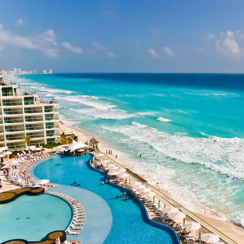 A resort area in Cancun with sun, beach and blue water