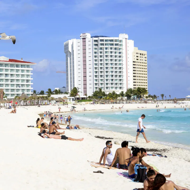 Travelers enjoying the sunny weather in a Cancun beach