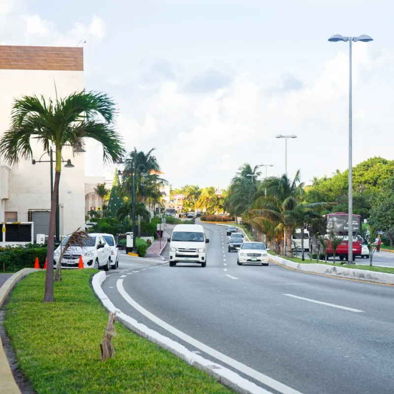 Cars Parked and Driving Down the Road in Cancun, Mexico