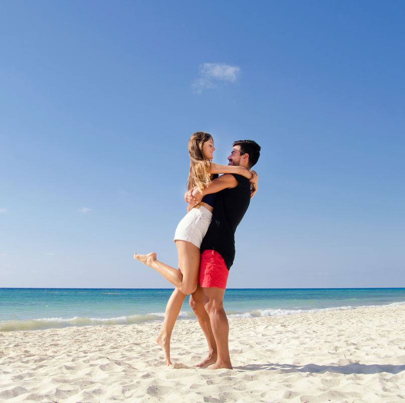 Couple embracing on a beach in cancun mexico
