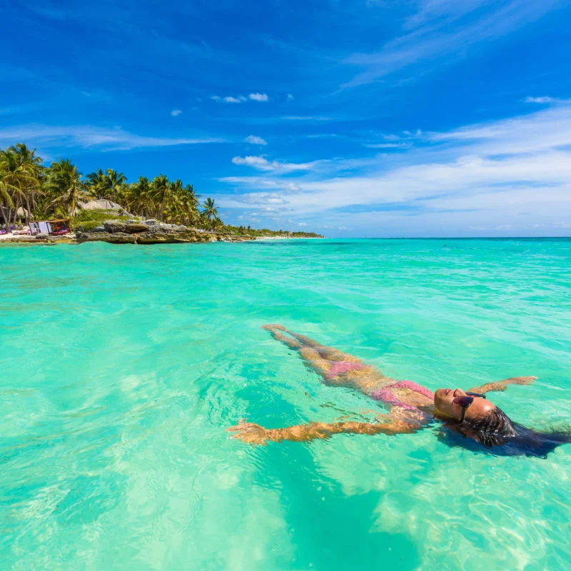 A woman floating on the sea in Cancun