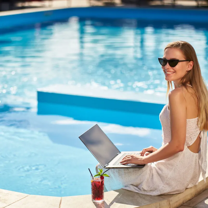 A guest enjoying a relaxing day by the pool at a hotel 