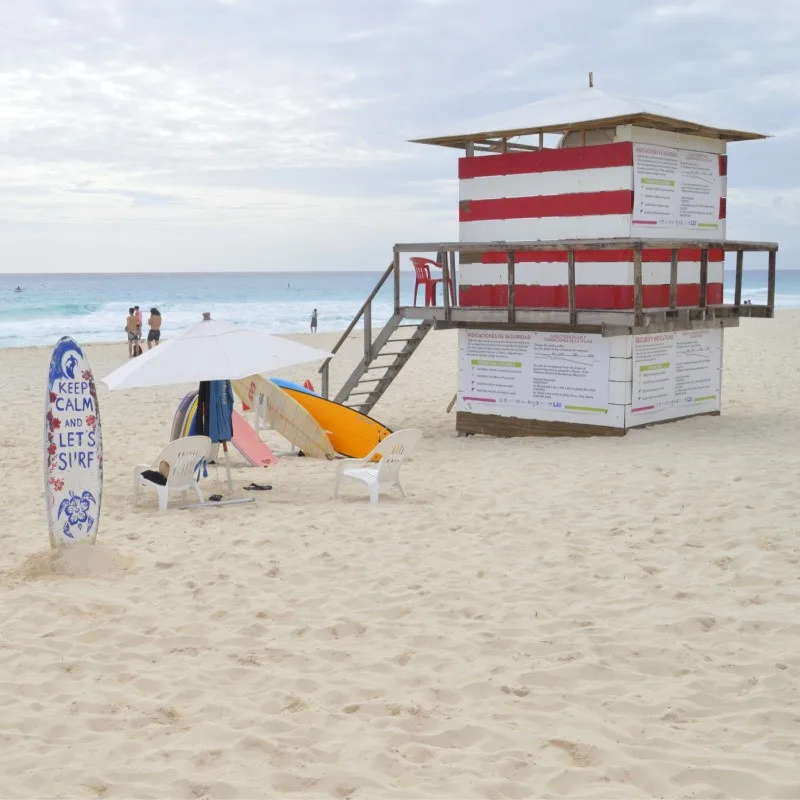 Lifeguard Station, People, and Surfboard on Playa Delfines in Cancun Mexico