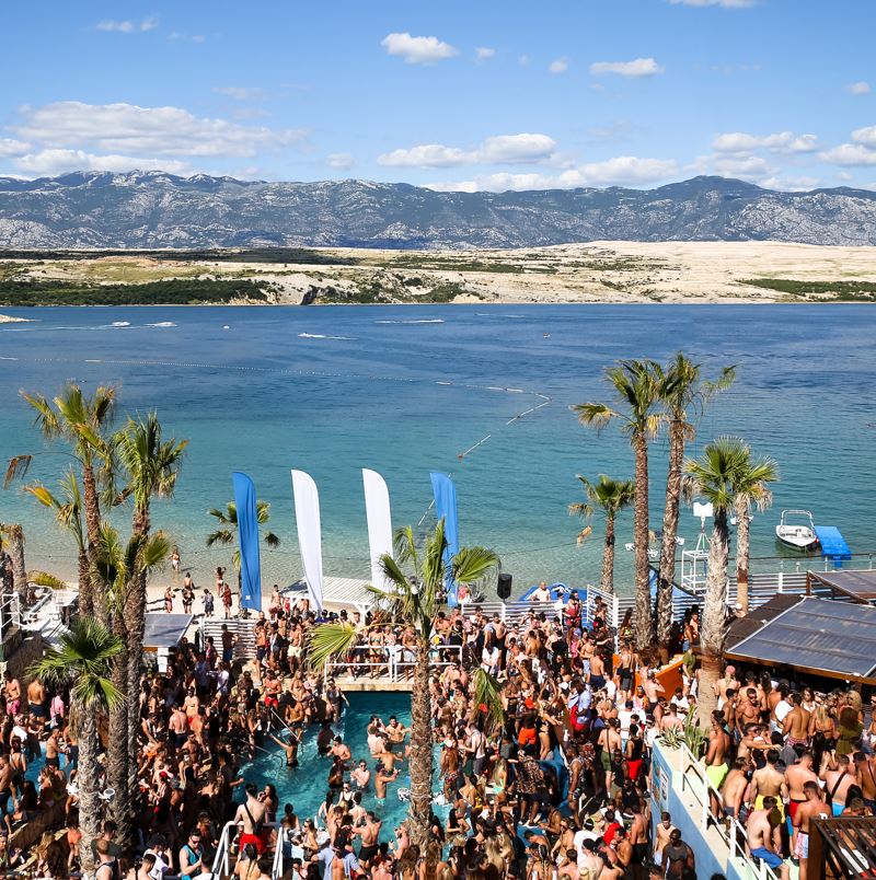 Loads of people in a massive pool party near a bay area