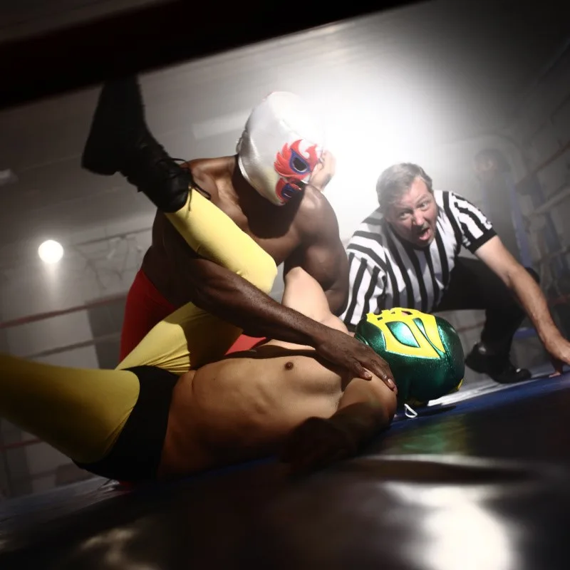 Lucha Libre Wrestlers and Referee In the Ring