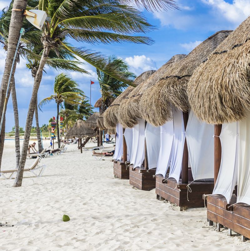 Luxury cabana on a white sand beach in Mexico at a high end all-inclusive resort