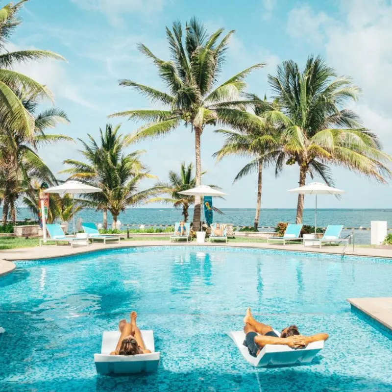 Poolside area with couple relaxing in the water in Cancun