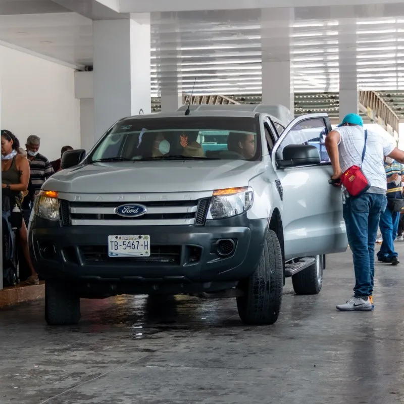 People Picking Up Rental Cars in Cancun, Mexico