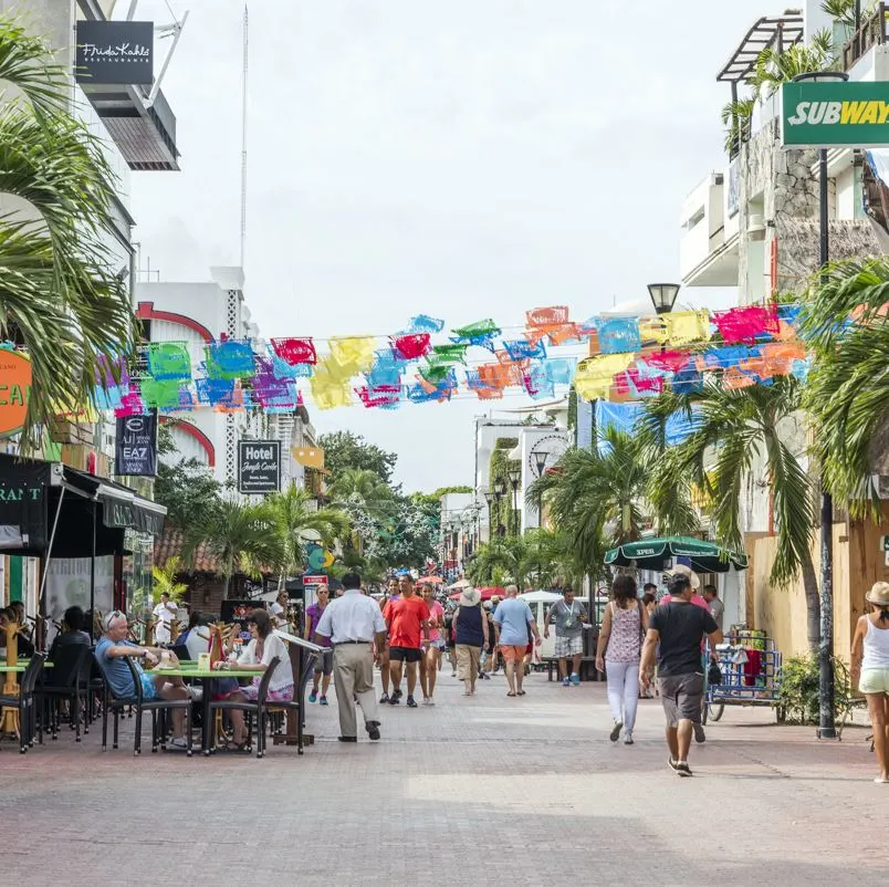 People walking down a street in playa del carmen