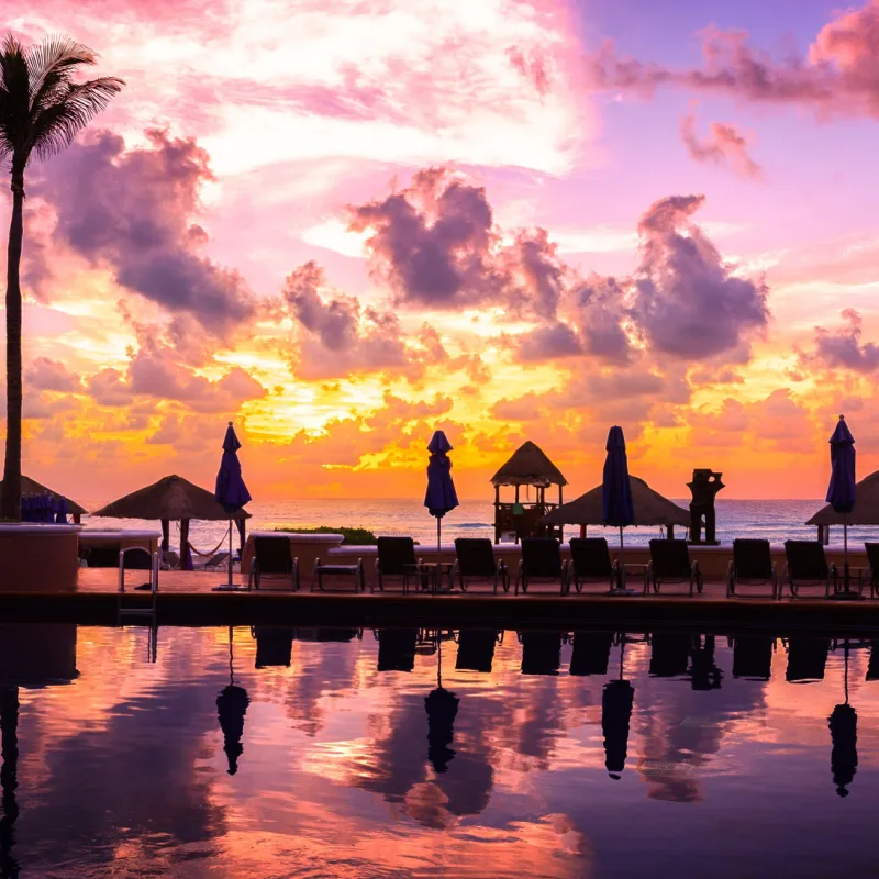 Sunset view of Cancun's resort area with palm trees