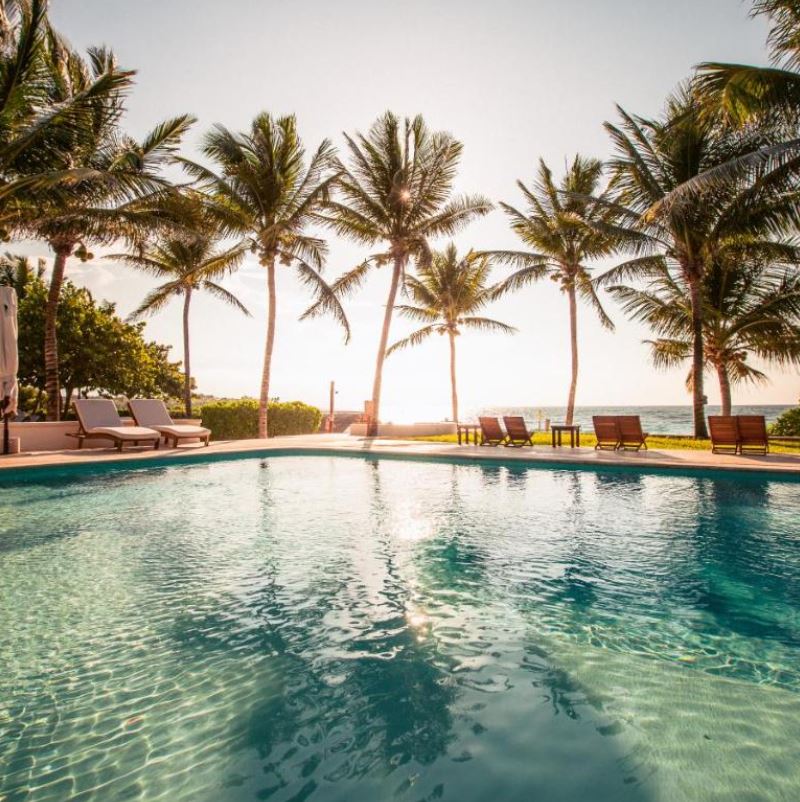 Pool of Hotel Esencia at sunset, riviera maya