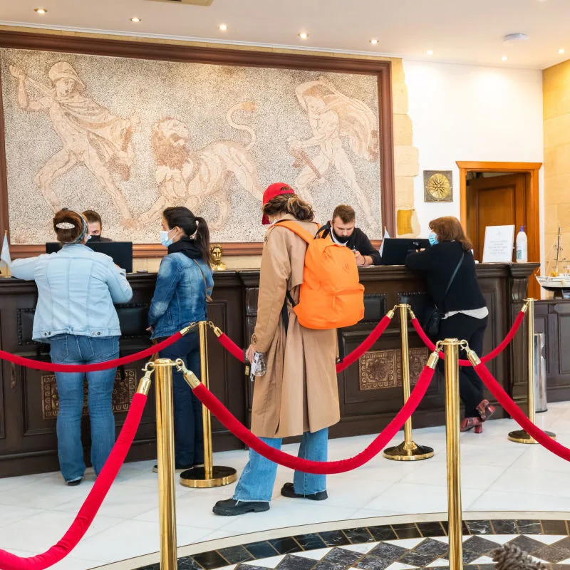 Guests lining up for check in at a busy hotel