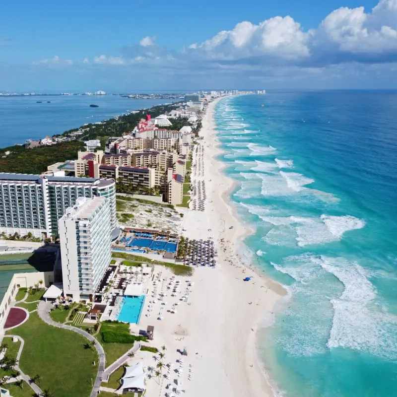 Beaches and Resorts in the Cancun Hotel Zone, bordered by the turquoise blue Caribbean Sea.