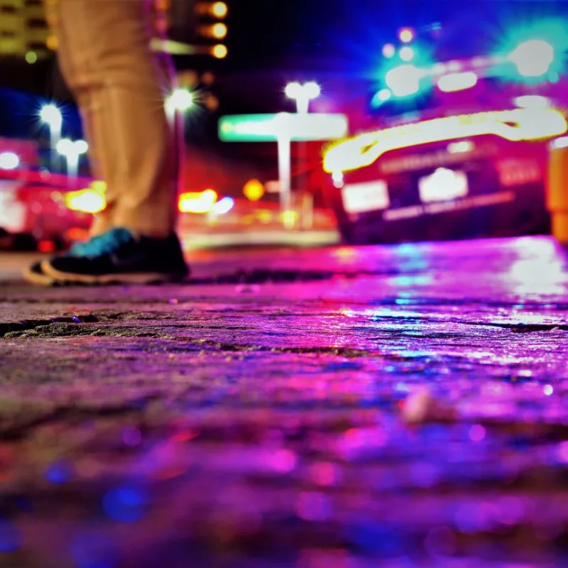 Police in Cancun at Night, man standing on the road.