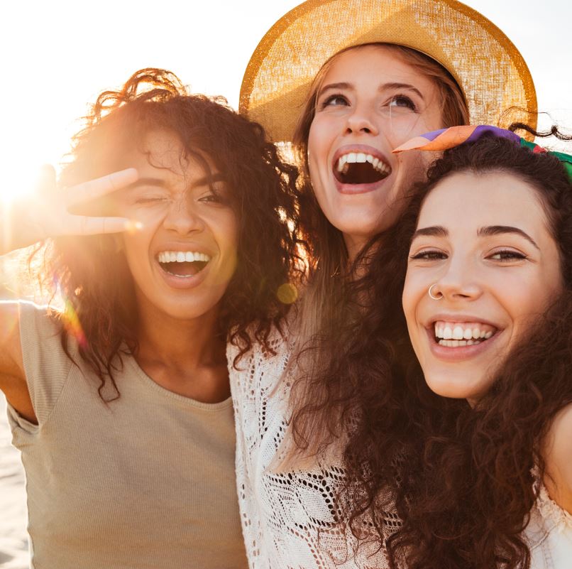 Three women taking a selfie on a beach
