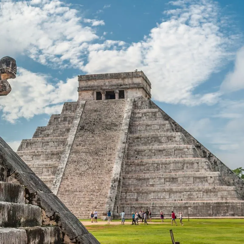 Tourists looking at chichen itza ruins