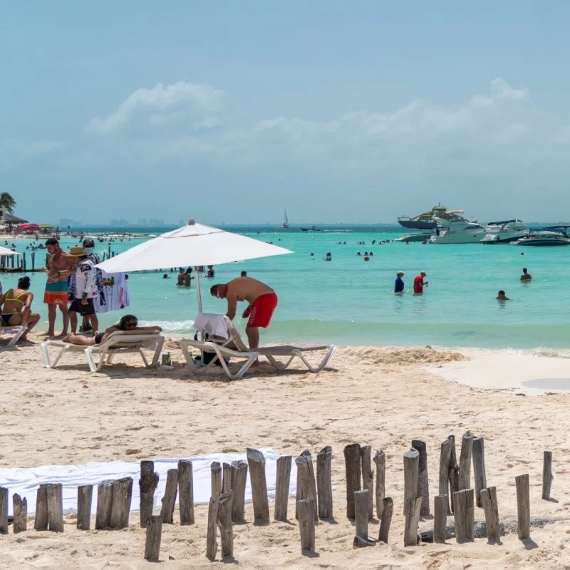 tourists on Playa Norte beach in Isla Mujeres, one of the best beaches in the world according to Trip Advisor travelers.